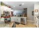 Open-concept kitchen features white cabinets, stainless steel appliances, and tile floors at 12918 Hunters Vista Blvd, Orlando, FL 32837
