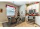 Bright kitchen with a stainless steel oven, white cabinets, and cozy dining area at 12918 Hunters Vista Blvd, Orlando, FL 32837