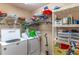 Laundry room with storage shelves, a washer and dryer, and cleaning supplies at 12918 Hunters Vista Blvd, Orlando, FL 32837