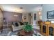 Living room featuring hardwood floors, modern sofa, and views of the dining area at 12918 Hunters Vista Blvd, Orlando, FL 32837