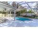 Screened pool with custom tile accents and spacious deck surrounded by lush landscaping creating a private backyard oasis at 12918 Hunters Vista Blvd, Orlando, FL 32837