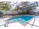 Relaxing screened-in pool with custom deck, landscaping, and outdoor seating areas providing an ideal space for entertainment at 12918 Hunters Vista Blvd, Orlando, FL 32837