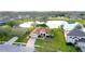 Beautiful single-story home with brick driveway surrounded by well-maintained landscaping with serene lake in the background at 1332 Hunterman Lane, Winter Garden, FL 34787