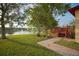 Backyard with lush landscaping and a peaceful view of the lake with fountain at 1332 Hunterman Lane, Winter Garden, FL 34787