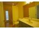 Brightly lit yellow bathroom features a tub/shower combo, vanity, and tile floors at 1332 Hunterman Lane, Winter Garden, FL 34787