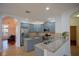 Modern kitchen with blue cabinets, granite countertops, stainless steel appliances, and recessed lighting at 1332 Hunterman Lane, Winter Garden, FL 34787