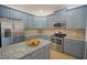 Kitchen area with an island, granite countertops, stainless steel appliances, and lots of cabinet space at 1332 Hunterman Lane, Winter Garden, FL 34787
