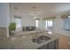 Kitchen area with granite countertops and a stainless steel sink overlooking the sitting room at 1332 Hunterman Lane, Winter Garden, FL 34787