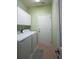 Functional laundry room with tile floors, appliances, and plenty of cabinet space at 1332 Hunterman Lane, Winter Garden, FL 34787