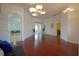Spacious living room with hardwood floors, decorative archways, and bright, natural lighting at 1332 Hunterman Lane, Winter Garden, FL 34787