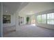 Spacious living room with carpet, decorative pillars, and doors to the outdoor patio at 1332 Hunterman Lane, Winter Garden, FL 34787