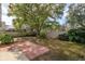 Landscaped backyard with patio and large tree at 14424 Quail Trail Ct, Orlando, FL 32837