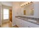 Double vanity bathroom with granite countertops at 14424 Quail Trail Ct, Orlando, FL 32837