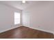 Neutral bedroom with hardwood floors, a ceiling fan, and a window for natural light at 14424 Quail Trail Ct, Orlando, FL 32837
