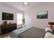 Bedroom with wood floors, dresser, and ceiling fan at 14424 Quail Trail Ct, Orlando, FL 32837