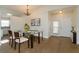 Modern dining room with glass table, chandelier and hardwood floors at 14424 Quail Trail Ct, Orlando, FL 32837