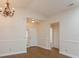 Bright dining room with hardwood floors, chandelier and view of entryway at 14424 Quail Trail Ct, Orlando, FL 32837