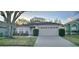 Charming single-story home featuring an attached two-car garage and mature landscaping at 14424 Quail Trail Ct, Orlando, FL 32837