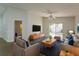 Spacious living room featuring hardwood floors, a large TV, and comfortable seating at 14424 Quail Trail Ct, Orlando, FL 32837