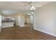 Open living room and kitchen with hardwood floors and ceiling fan at 14424 Quail Trail Ct, Orlando, FL 32837