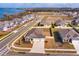 Aerial view of a beautiful home with a three-car garage near the water and a large undeveloped parcel at 14436 Topaghan Way, Winter Garden, FL 34787