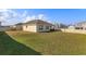 Large backyard with lush grass and tall privacy fence surrounding property at 14436 Topaghan Way, Winter Garden, FL 34787