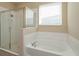Bathroom features a soaking tub and glass-enclosed shower at 14436 Topaghan Way, Winter Garden, FL 34787