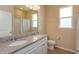 Bathroom featuring double sink granite vanity, framed mirror, and tile flooring at 14436 Topaghan Way, Winter Garden, FL 34787