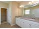 Bathroom with double vanity, granite countertops, and tile floors leading to a walk-in closet at 14436 Topaghan Way, Winter Garden, FL 34787