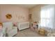 Charming Bedroom featuring a crib, glider, and storage at 14436 Topaghan Way, Winter Garden, FL 34787