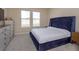 Bedroom with large windows and a plush bed at 14436 Topaghan Way, Winter Garden, FL 34787