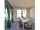 Dining area features a decorative light fixture, large windows, and sliding glass doors to the backyard at 14436 Topaghan Way, Winter Garden, FL 34787