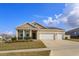 Charming single-story home featuring a three-car garage, well-manicured lawn, and welcoming entryway at 14436 Topaghan Way, Winter Garden, FL 34787