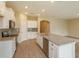 Bright kitchen with stainless steel appliances, granite countertops, a large island, and white cabinets at 14436 Topaghan Way, Winter Garden, FL 34787