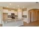 Modern kitchen boasts stainless steel appliances, white cabinetry, granite countertops, and a kitchen island at 14436 Topaghan Way, Winter Garden, FL 34787