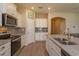 Bright kitchen with stainless appliances, granite counters, white cabinets, and eat-in island at 14436 Topaghan Way, Winter Garden, FL 34787