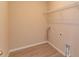 Laundry room with wood look tile and wire shelving at 14436 Topaghan Way, Winter Garden, FL 34787