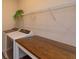 Convenient laundry room includes a folding table and an overhead storage shelf at 14436 Topaghan Way, Winter Garden, FL 34787