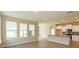 Open living space with large windows, seamlessly connected to a modern kitchen with an island at 14436 Topaghan Way, Winter Garden, FL 34787