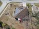 Aerial view of house showing solar panels on roof and backyard patio at 1523 Whooping Dr, Groveland, FL 34736