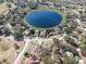 Wide aerial view of neighborhood and lake at 1523 Whooping Dr, Groveland, FL 34736