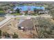 Aerial view of house near lake with solar panels on roof at 1523 Whooping Dr, Groveland, FL 34736