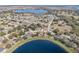 Broad aerial view of homes and lakefront community at 1523 Whooping Dr, Groveland, FL 34736