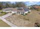 House with solar panels, driveway, and landscaping at 1523 Whooping Dr, Groveland, FL 34736
