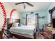 Baseball-themed bedroom with a double bed and built-in shelving at 1523 Whooping Dr, Groveland, FL 34736