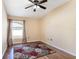 Bright bedroom with floral rug and large window at 1523 Whooping Dr, Groveland, FL 34736