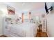 Bedroom with a white bed frame, dresser and desk at 1523 Whooping Dr, Groveland, FL 34736