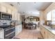 Open concept kitchen with stainless steel appliances and breakfast nook at 1523 Whooping Dr, Groveland, FL 34736
