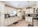 Modern kitchen with granite countertops and white cabinets at 1523 Whooping Dr, Groveland, FL 34736