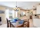 Bright kitchen with light cabinets, granite counters, and an eat-in area at 1523 Whooping Dr, Groveland, FL 34736